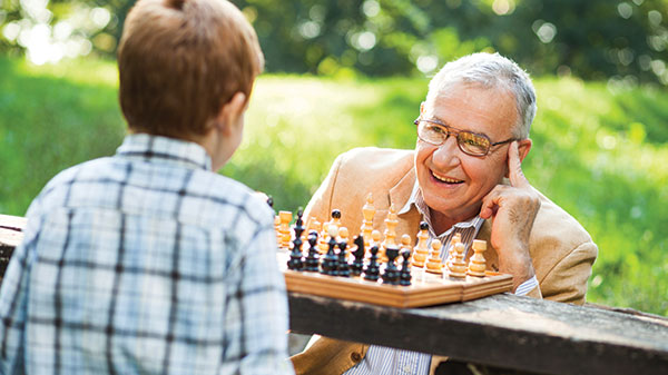 A man and child playing chess